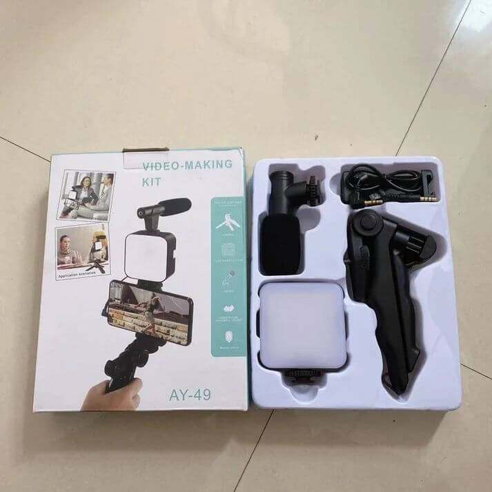 smartphone and camera vlogging studio kit with tripod, microphone, LED light, and accessories in packaging for video filming stability